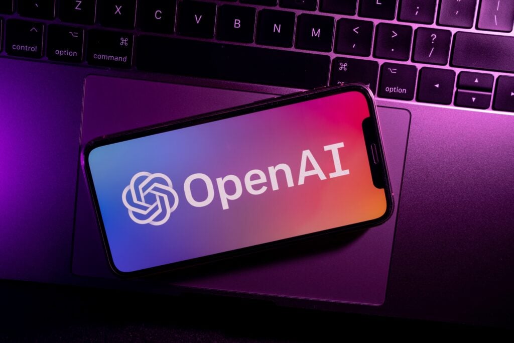 Smartphone On Laptop Showing OpenAI Logo
