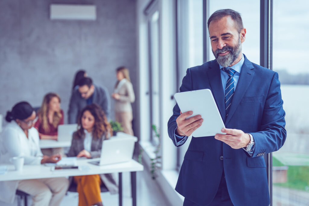 man looking at tablet in office